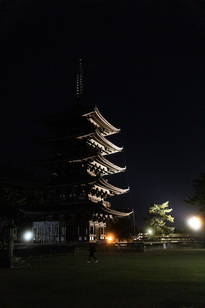 The five story pagoda at Kōfuku-ji lit up at night with a spotlight.